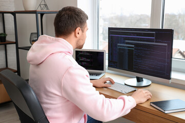 Focused male programmer working in office