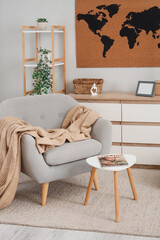 Wall Mural - World map on wall, armchair, chest of drawers and shelving units in interior of living room