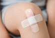 © Robert Garcia - Child's scraped knee with bandage, close-up detail shot, soft focus, healthcare and medical image for blogs, websites, and articles.