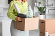 © Pixel-Shot - Young businesswoman with cardboard box of belongings in office on moving day, closeup