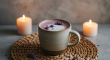 Cozy lavender latte in a ceramic cup surrounded by lit candles on a woven placemat