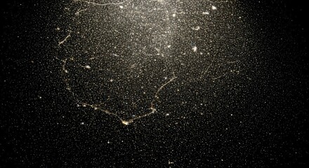 Close-up view of dust particles illuminated by a light source against a dark background, revealing intricate patterns and textures.