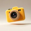 © Ananto - Bright yellow plush camera toy presented against a neutral background, emphasizing its soft texture, unique form, and playful aesthetic, making it ideal for kids and imaginative photographers.