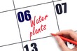 © Alena - 6 th day of the month. Hand writing Water plants reminder on calendar with red pen on white background. concept of plant care. Planning and scheduling