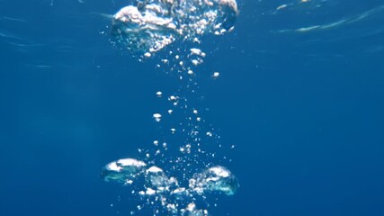 Wall Mural - abstract seamlessly looping video of shimmering underwater bubbles slowly rising with beautiful ligh
