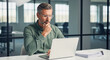 © InfinityVisuals - Focused in Office: A middle-aged professional, deep in concentration, analyzes data on a laptop in a modern office environment. Capturing a moment of focused work and analytical thought.