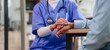 © PRIME STOCK LAB - Young nurse caring patient with hand support, compassionate healthcare worker offering comfort and reassurance in clinic setting