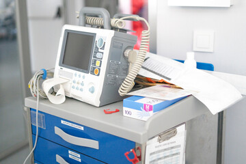 Defibrillator standing on crash cart in hospital room