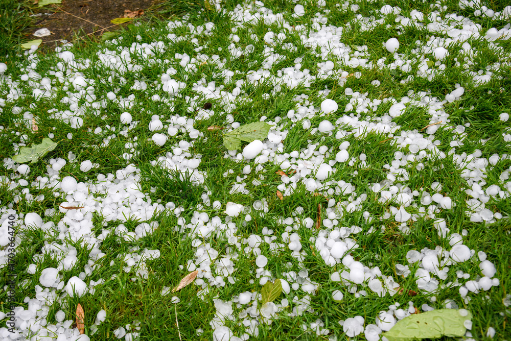 Aftermath of a hailstorm with large chunks of ice scattered across ...