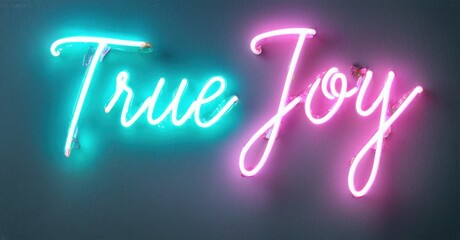 Bright neon sign displays words True Joy using vibrant pink, turquoise colors. Dark background enhances glowing script lettering.