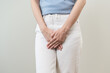 © KMPZZZ - Vaginal, urinary incontinence. Pain asian young woman hand holding crotch suffering from pain, itchy or scratch of vagina, genital itching from infection. Gynecological problems menstrual disorder