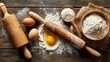 © mila103 - A rustic wooden table is set with essential cooking ingredients including eggs, flour in a bowl, and a cracked egg, ready for baking activities in a home kitchen.