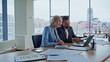 © stockbusters - Partners laptop video call at panoramic workspace closeup. Coworkers talking