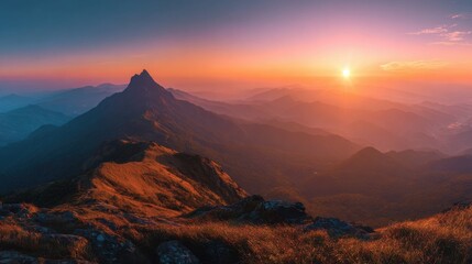 Wall Mural - A breathtaking sunset unfolds over a majestic mountain range, with a prominent peak silhouetted against the vibrant orange and purple sky, creating a serene atmosphere.