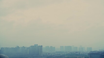 Wall Mural - Time lapse of dark clouds over the city buildings