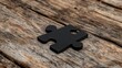 © afridwi - Single black puzzle piece on rustic wood background