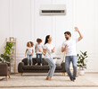 © New Africa - Happy family having fun in living room. Air conditioner keeping comfortable temperature in room