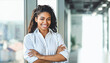 © Prostock-studio - Black Businesswoman Smiling At Camera Posing Standing In Modern Office. Free Space