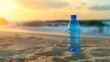 © afridwi - Water bottle on sandy beach at sunset