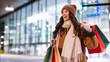 © Home-stock - Excited lady holding shopping bags and smiling, preparing for winter holidays and buying Christmas presents, carrying purchases while standing outdoors