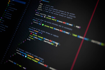 close-up of colorful programming code on screen showing console.log with action start, end, and fail