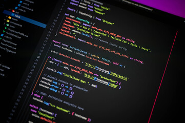 colorful programming code on screen showing vite, vue 3, typescript, tailwind, pinia, and axios conf