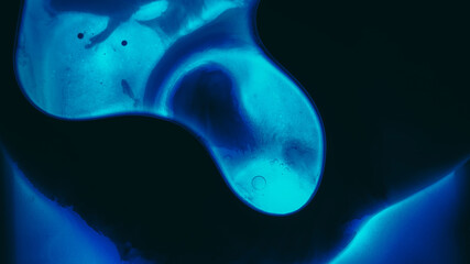 Wall Mural - Fluid texture. Liquid mix. Defocused blue neon color water drop glow paint ink dark black flow oil blob floating on abstract light background.