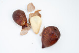 An arrangement of two spiky brown salak fruits, one peeled to show its pale white flesh, with scattered pieces of scaly peel on a white background.