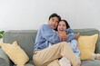 © sorapop - Winter cold day, happy couple finds warm home comfort inside, family love felt, winter season brings joyful moments, peaceful relaxation, sharing happiness together at home