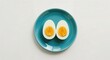 © png stock - Two halves of a hard boiled egg on a teal oval plate