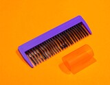 Vibrant comb and tube on orange background