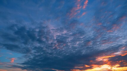 Wall Mural - A sunset sky timelapse illustrates the beauty of transition, the calm after the storm, and the promise of tomorrow reflecting resilience, peace, and the ever-changing nature of life.
