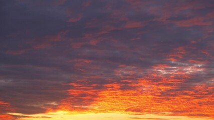 Wall Mural - a sunrise sky timelapse, painted in fiery orange and deep purple, conveys the concept of renewal, sy