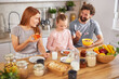 © Stockphotodirectors - A family shares a joyful breakfast at a kitchen table filled with fruits, cereals, and homemade bread. They engage in warm conversation, creating a lively morning atmosphere.