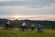 © Halfpoint - Family riding bicycles at sunset in mountains. Cycling trip during autumn day.