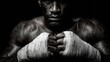 © jitharanat - Low-key dramatic image of a boxer wrapping his hands in preparation for an intense training session