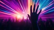 © NDmCX-Nic - A vibrant scene of a crowd at a concert with colorful light beams and a hand reaching up, embodying the excitement of live music.