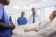 © ReeldealHD images - Healthcare Team giving patient results in a hospital ward