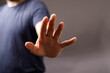 © vegefox.com - Close-up image of a man's hand gesturing to stop, conveying refusal, rejection, or caution. Perfect for concepts of denial, prohibition, and boundaries.