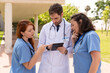 © StockMe - Medical professionals analyzing patient information on digital tablet, sharing clinical insights collaboratively