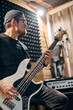 © TRAVELARIUM - Bassist in action during music band rehearsal