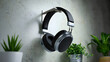 © shanto - Headphones on wall: A sleek set of headphones elegantly suspended on a minimalist wall mount, flanked by verdant potted plants, creating an atmosphere of tranquil audio sanctuary.
