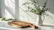 © gfxdesigner_tania - Rustic wooden cutting board with eucalyptus in a white vase