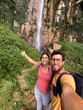 © Luis Herrera/Stocksy - Couple Travel Selfie at a Waterfall
