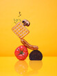 © French Anderson Ltd/Stocksy - A balanced pile of breakfast food items graphic colourful