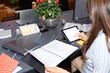 © Moy Ortega/Stocksy - Office worker seated at a desk in a coworking using a digital tablet