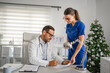 © Miljan Živković - Doctor and nurse working together in medical office during christmas time