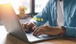 © Orbit - Person typing on laptop with digital overlay showing five-star rating and security padlock icon, set in indoor workspace with blurred table and plant in background, representing user feedback, online
