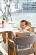 © Marc Tran/Stocksy - Happy Baby at Lunch while sitting in a high chair