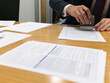 © Rowena Naylor/Stocksy - Lawyer Professional Stamping Documents on Office Desk